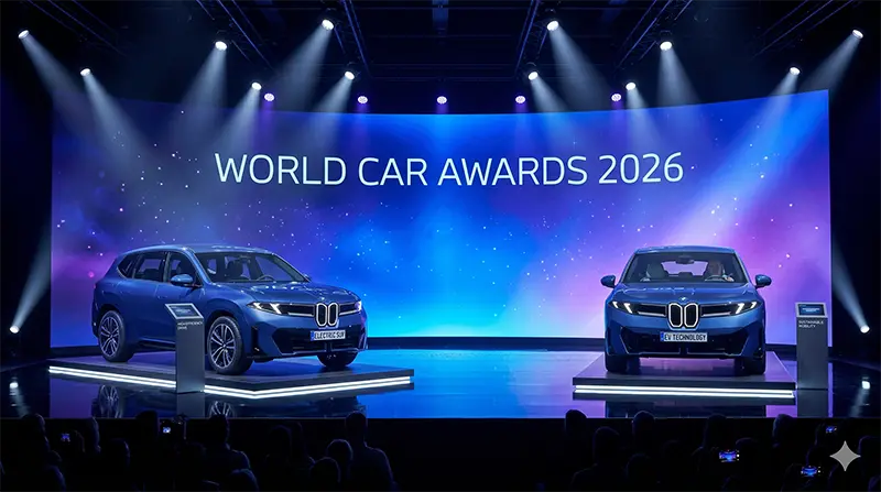 Launch event scene with BMW iX3 electric SUVs on stage under spotlight beams with LED screen displaying World Car Awards 2026 headline