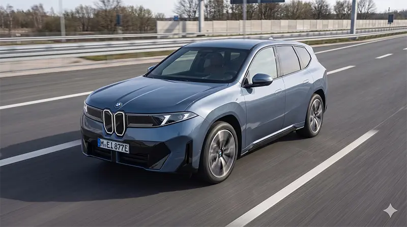 Dynamic low-angle action shot of BMW iX3 driving on highway with motion-blurred background conveying speed while vehicle stays in sharp focus