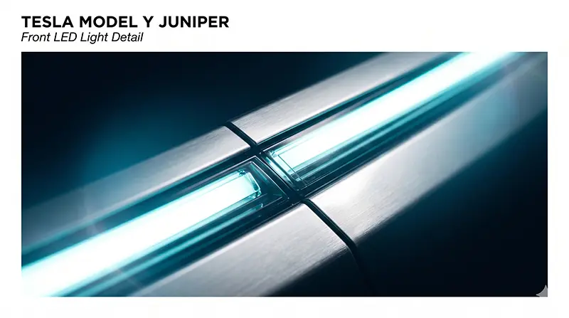 Macro close-up of Tesla Model Y Juniper’s full-width LED light bar with continuous illuminated signature