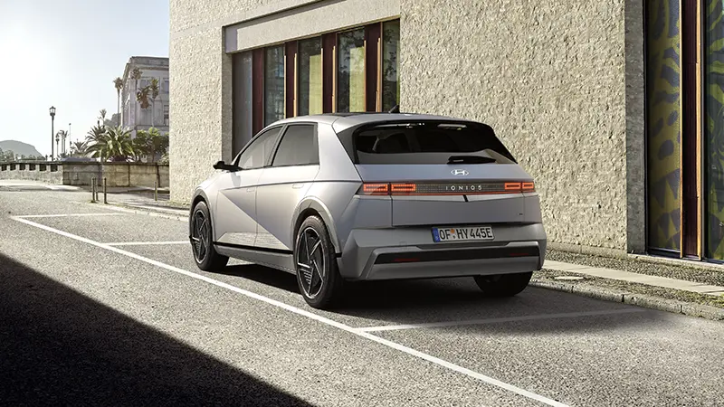 Three-quarter rear angle of Hyundai IONIQ 5 emphasizing parametric pixel rear light bar and vehicle silhouette