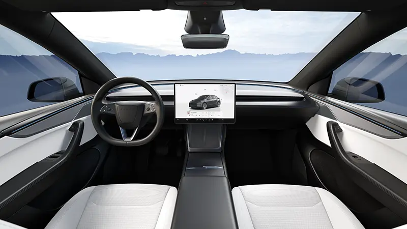 Tesla Model Y minimalist interior with large horizontal touchscreen display and clean dashboard layout